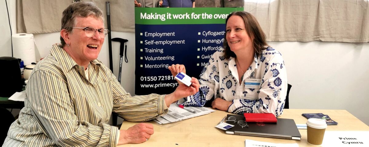 PRIME Cymru's Tracy Eynon and client Karen Harris smile as Karen hands Tracy her business card