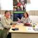 PRIME Cymru's Tracy Eynon and client Karen Harris smile as Karen hands Tracy her business card