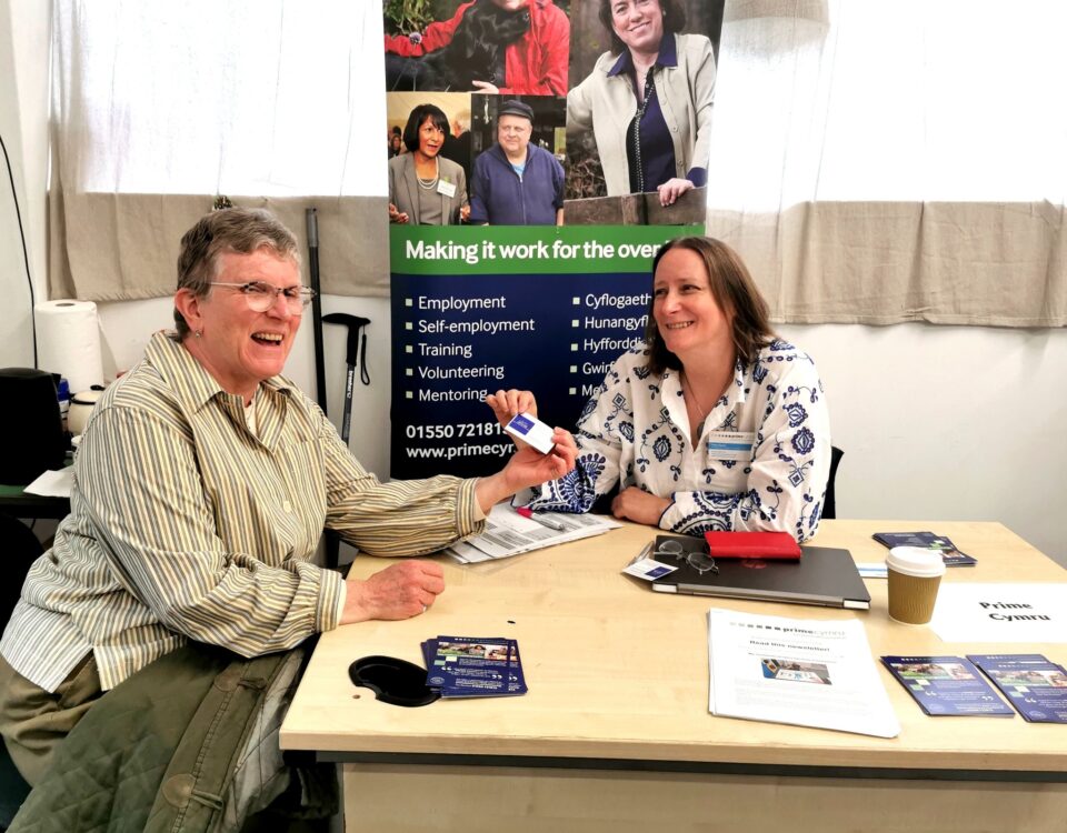 PRIME Cymru's Tracy Eynon and client Karen Harris smile as Karen hands Tracy her business card