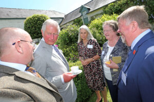 Hugh and Ann smile as they chat to HM The King