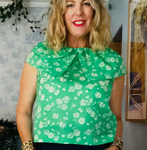 Debra poses for the camera in a green floral shirt